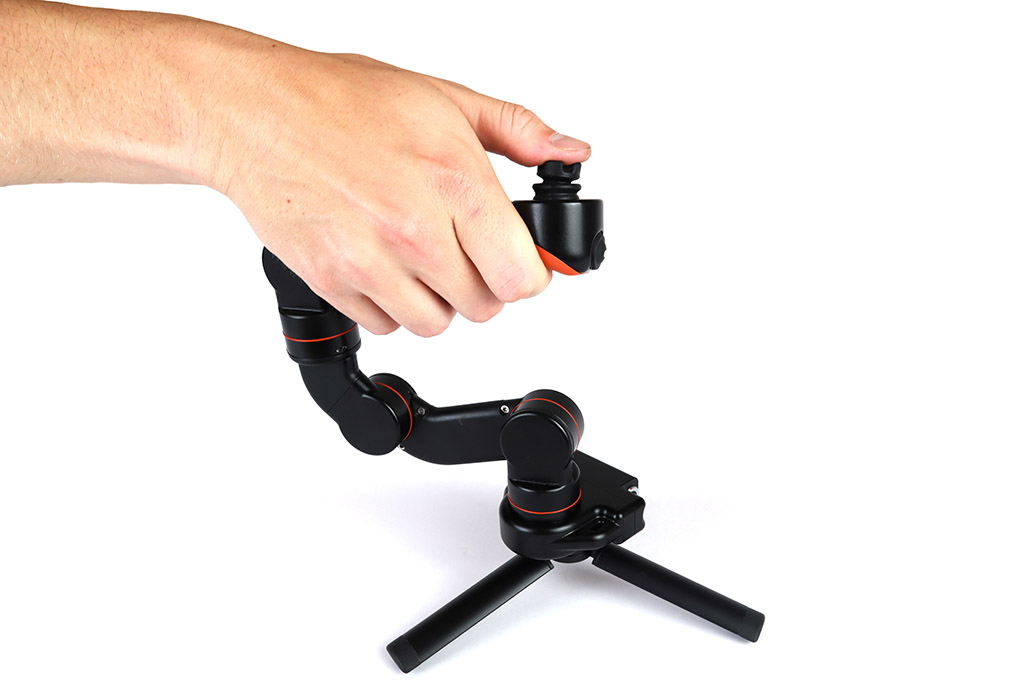 A compact articulated robotic manipulator being controlled by hand