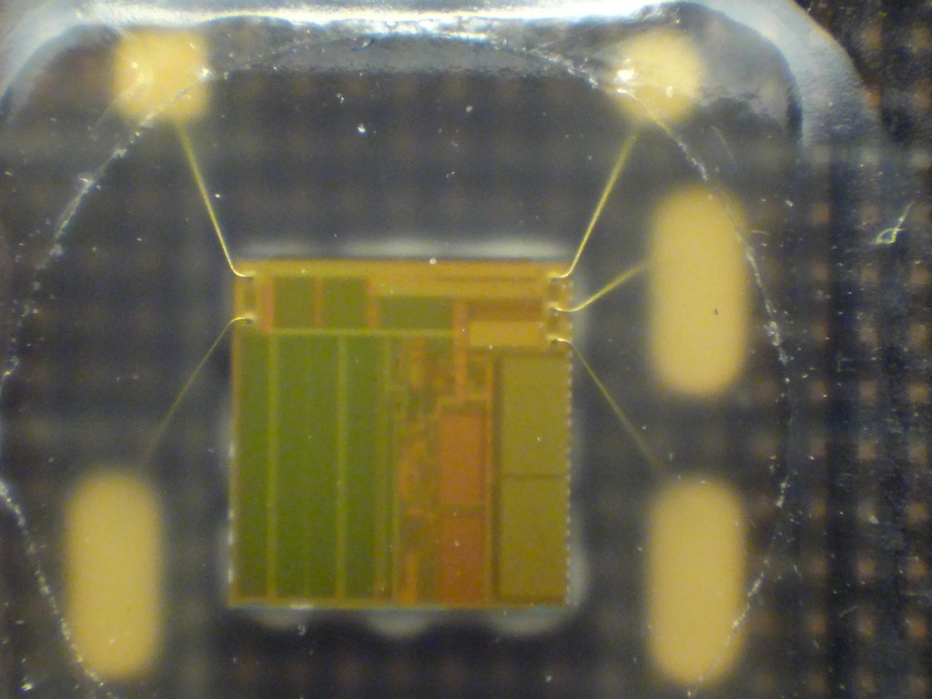 A silicon chip exposed inside a dismantled SIM card