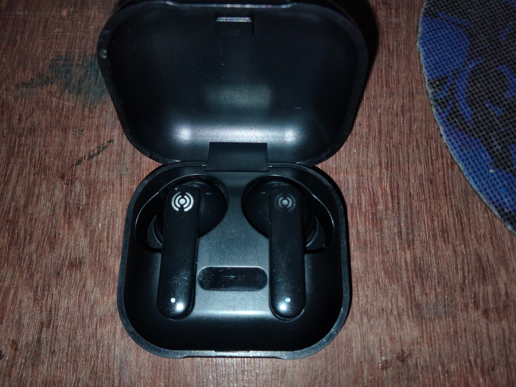 A pair of true wireless earbuds in their charging case