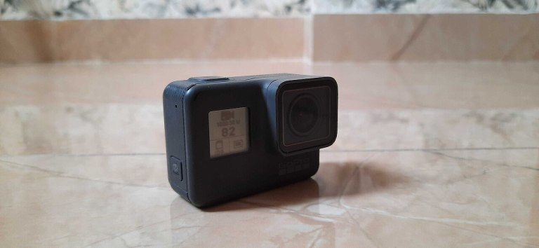 A compact action camera photographed on a tabletop