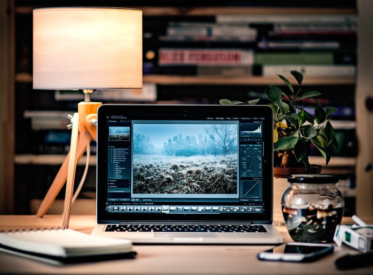 A slim laptop on a desk in a compact workspace