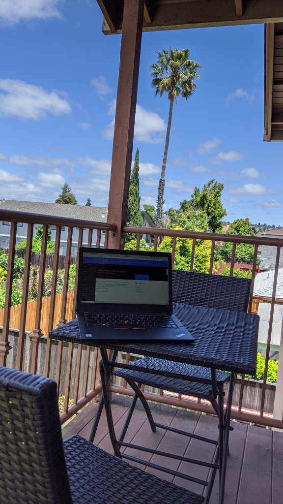 A laptop being used in an outdoor workspace